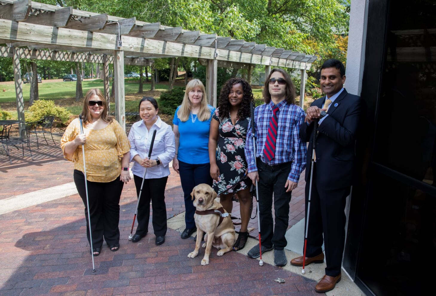 DSDHH Deaf/DeafBlind Services Coordinator Ashley Benton, flanked by sign language interpreters, leads a DeafBlind training